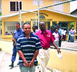 The accused being escorted by police ranks