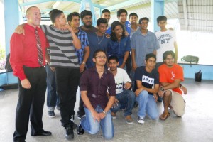 Andrew Hanoman (first from left kneeling) poses with fellow 2012 National Scholarship Winners of Presentation College, Chaguanas and prinicpal