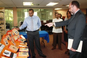 Caricom Secretary General Irwin LaRocque points to a book that grabbed his attention from a collection presented by Culture, Youth and Sport Minister, Dr Frank Anthony, on various aspects of Guyana’s history