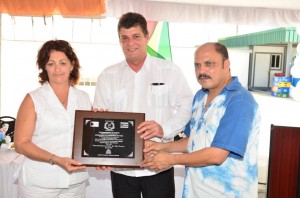 Health Minister Dr Bheri Ramsaran presents a plaque to Cuban Ambassador to Guyana Raul Gortázar Marrero, in honour of the 40th anniversary of the Guyana Cuba medical brigade