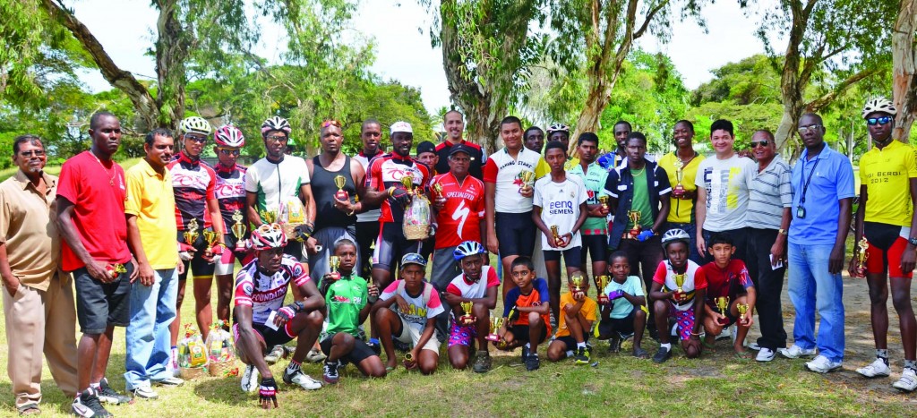 Representatives of Ricks and Sari Agro Industries and national coach Hassan Mohamed (third from right) pose with the top performers of the various categories (Photos: Avenash Ramzan)