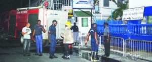 Firemen outside the Culture, Youth and Sport Ministry’s annexe at Middle Street, Georgetown, moments after putting out the fire