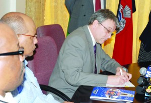 Capita Symonds Associate Director Paul Wadsworth signs the agreement that will foresee the continued consultancy of the firm in the development of the Guyana Police Force