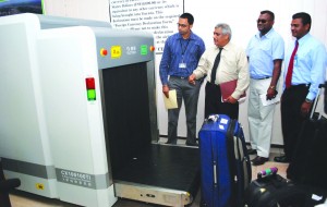 GRA Commissioner General Khurshid Sattaur (second from left) shares a word with CJIA Chief Executive Officer Ramesh Ghir (right) as they observe the baggage scanner at work