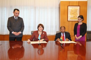 Guyana’s permanent representative to the United Nations, Ambassador George Talbot and the Kazakhstan permanent representative, Ambassador Byrganym Aitimova pose for the cameras after the signing ceremony while their representatives look on