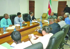 Natural Resources and Environment Minister Robert Persaud (third left) and his Surinamese counterpart Jim Hok (fourth left) in discussion on mining sector cooperation between the two countries