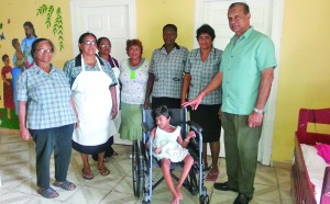 Caretakers of the Hope Children’s Home with little Shereen Ally and mandir representative Mochan Persaud (right)