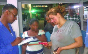 The wife of the deceased (right) giving her statement to a police rank at the hospital