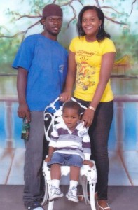 In happier times... This photograph shows the 4-year-old boy who was stabbed to death at Linden on Wednesday flanked by his mother and his stepfather Rawle Samuels.