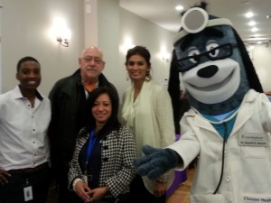 Mascot Dr. Health E.Hound with United Health Care Director, staff and health fair host Shanie Persaud of GABPC