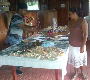 Santa Mission Craft Centre Chairman Martina Samuels selling craft to a tourist