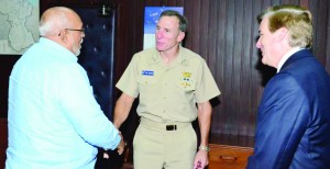 Vice Admiral Joseph D Kernan, the deputy commander of the U.S. Southern Command, greets President Donald Ramotar while U.S. Ambassador to Guyana, D Brent Hardt looks on