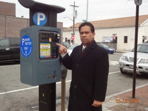 Community advocate Albert Baldeo points to a typical new muni-meter  