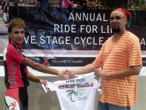 Paul DeNobrega receives a jersey from Team Coco’s owner, Ian “QB” Davis, after copping the junior title of the “Ride for Life” Five-Stage cycling event last year