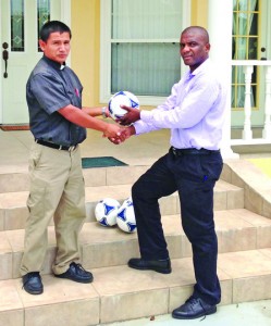 Operations Manager (Technical) George Walker for Guyana Times/RGI 89.3/89.5/89.7 FM makes the presentation to Father Umberto Villa