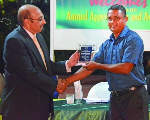 GOA’s Sports Journalist of the Year, Avenash Ramzan of Guyana Times/TVG Channel 28, receives his award from GOA’s head KA Juman Yassin at Friday’s function (Photo: Treiston Joseph)