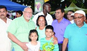 President Donald Ramotar poses with one of the many families who were present at the Family Fun Day at State House