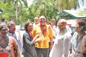 President Donald Ramotar, First Lady Deolatchmie Ramotar and Deputy Indian High Commissioner Therat Singh share a light moment with other Phagwah celebrants