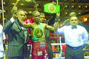 CABOFE champ! President of the GBBC, Peter Abdool (left), and referee Manuel Burgos with new featherweight champion Clive Atwell