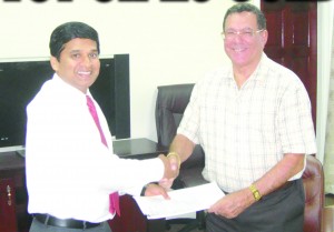 Dr Ranjisinghi Ramroop (left) and Anthony Vieira were all smiles as they shook hands after the sale of VCT was finalised in 2009