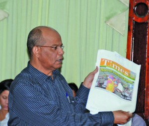 Home Affairs Minister Clement Rohee displays a copy of the Guyana Times to illustrate the point that Guyanese are feeling safe as is evident by their large turnout at events to mark public holidays