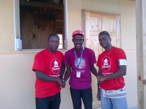 George (left) and Johnson shaking hands with one of the happy homeowners