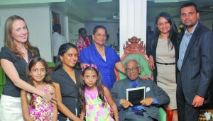 Reepu Daman Persaud (sitting) with his family on the day he was honoured by Parliament