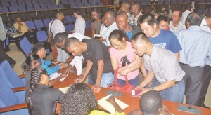 Foreign nationals giving their details to officials of the Home Affairs Ministry so that their work permit and extension of stay papers can be dealt with expeditiously 