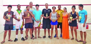 All the winners of the ANSA McAL Squash Easter tournament pose with their winning trophies