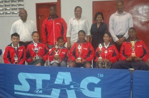 Members of the national table tennis team posing with their silverware Wednesday, along with the coaching staff and officials of the GTTA