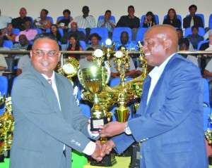 Guyana Times/TVG 28 news anchor and sports journalist Avenash Ramzan (left) receives his award from Deputy Permanent Secretary of the Ministry of Sport, Steve Ninvalle