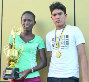 Alika Morgan (left) and Samuel Kaiton pose with their trophy and medal respectively