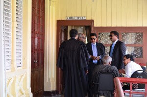 Attorney General and Legal Affairs Minister Anil Nandlall chatting with opposition lawyers Basil Williams and Khemraj Ramjattan (backing camera) prior to entering the chamber of Justice Ian Chang. Senior Counsel Ralph Ramkarran is also in this GINA photo