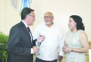 Argentine Ambassador to Guyana Luis Martino (left) in discussion with President Donald Ramotar and Foreign Affairs Minister Carolyn Rodrigues-Birkett during a reception held at the Pegasus Hotel to mark the 203rd anniversary of Argentina's 1810 May Revolution (Carl Croker photo)