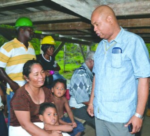 Junior Finance Minister Juan Edghill with the family of Michael Williams