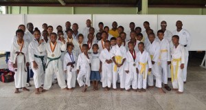 The students who participated in the championship pose with Sensei Winston Dunbar; Darren Nurse, president of the Guyana Wado Ryu Karate Association; and other officials