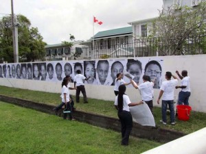 Pasting posters of the photos taken by the youths on the Canadian High Commission walls