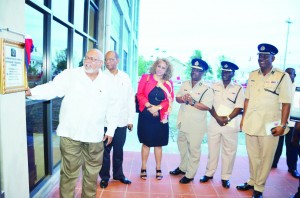 President Donald Ramotar unveils the plaque at the newly-commissioned Police Officers’ Training Centre in the presence of Home Affairs Minister Clement Rohee, IDB Representative Sophie Makonnen, acting Police Commissioner Leroy Brumell, Assistant Commissioner George Vyphuis, and another officer