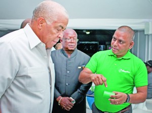 Jamaica’s Water, Land, Environment and Climate Change Minister Robert Pickersgill (left) examines piping material on display at the launch and exhibition of eZeeflow PPR-C HDPE pipes and fittings at the Spanish Court Hotel in Kingston, Jamaica on May 30. Technical adviser of QAII Parmanand Samaroo (right) explains features of the product, while PCL Managing Director Derven Patrick (centre), observes