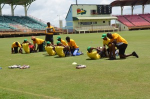 Veerasammy Permaul, Trevon Griffith, Krishmar Santokie and William Perkins doing their share of sit-ups during training on Tuesday