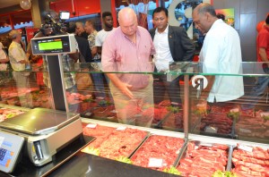 Owner of Rossignol Butcheries, Gerrald Van Dijk showing his products to Agriculture Minister Dr Leslie Ramsammy and Surinamese Trade Minister Raymond Sapoen