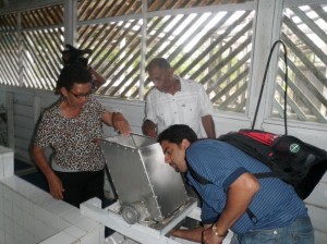 Agriculture Minister Dr Leslie Ramsammy inspects a piece of equipment during his tour of the Tapakuma Cassava Factory. Also in photo are Toshao Doreen Jacobus and Aditya Persaud of the ministry