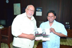 Professor David Dabydeen presents a copy of Janet Jagan: National Assembly Speeches volumes one and two, which were recently published by the Caribbean Press to President Donald Ramotar