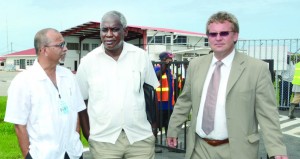 Proud moment: European Union Delegation Head Ambassador Robert Kopecký (right); Transport Minister Robeson Benn (centre) and Guyana Civil Aviation Authority chief Zulfikar Mohammed (left) witness the landing of the LIAT Airlines’ inaugural flight at the Ogle International Airport. (Carl Croker photos)