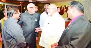 President Donald Ramotar in discussion with Professor Clement Sankat of the University of the West Indies at a forum held at the Crowne Plaza hotel, Port of Spain. Also in photo are Finance Minister Dr Ashni Singh and Public Works Minister Robeson Benn