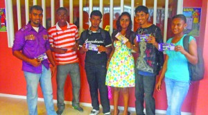 These cheerful cricket fans display their LCPL tickets after purchesing them at the local ticketing office on Friday afternoon