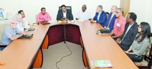 Acting Tourism, Industry and Commerce Minister Irfaan Ali (in centre) flanked by Transport Minister Robeson Benn (right), Caribbean Airlines Limited (CAL) Chairman Philip Marshall, along with other CAL executives and members of the private sector 