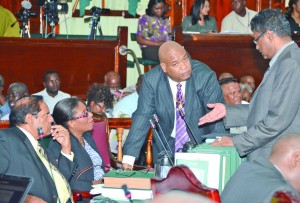 Alliance For Change (AFC) Leader Khemraj Ramjattan in discussion with Junior Finance Minister Juan Edghill and fellow AFC MPs Moses Nagamootoo and Cathy Hughes during Wednesday's sitting of the National Assembly