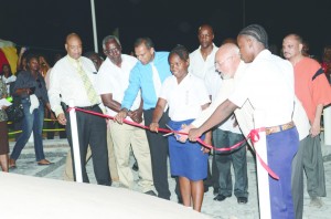 President Donald Ramotar cuts the ribbon to unveil the 1823 Slave Revolt Monument. He is assisted by students from Kuru Kuru Training College. Looking on are Culture Minister Dr Frank Anthony, Public Works Minister Robeson Benn, Junior Finance Minister Juan Edghill, Health Minister Dr Bheri Ramsaran and others 