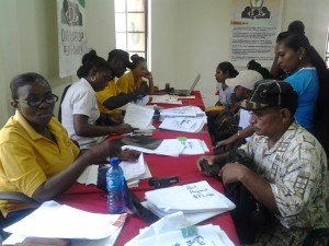 Region Two residents making their payments to staff of the Housing and Water Ministry for their new house lots